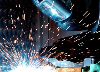 man welding steel during fabrication